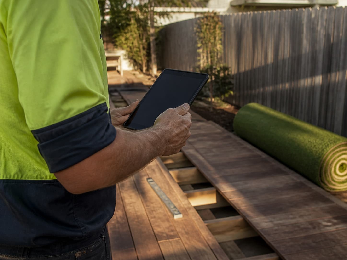 An Australian installer planning a deck and turf job on a tablet